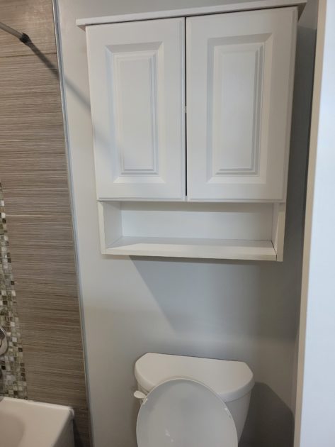 cleaned bathroom view of toilet and cabinet