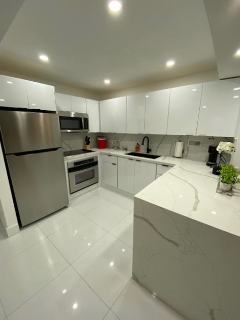 recently cleaned marble kitchen view of fridge