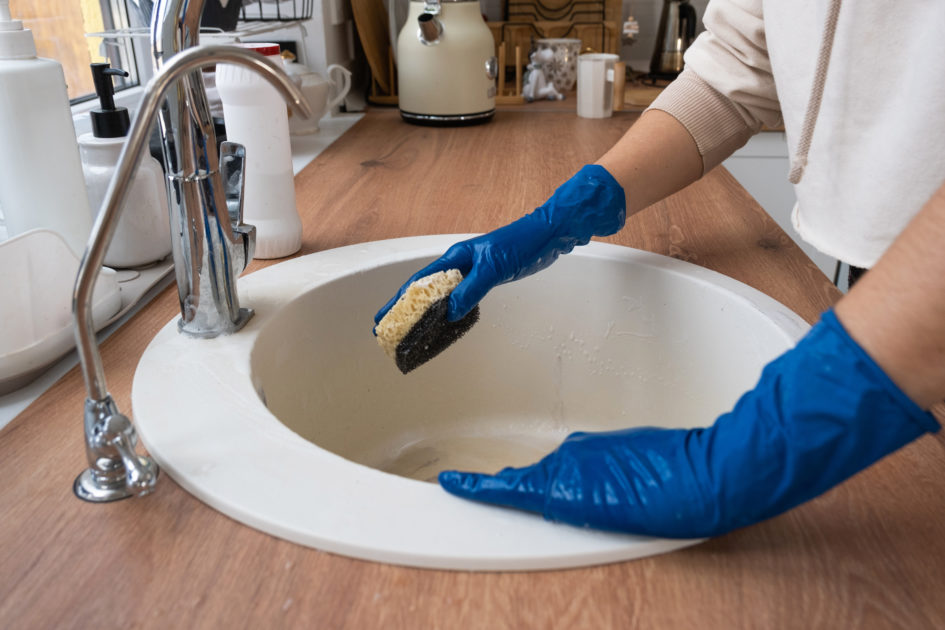 Sparkling clean stainless steel kitchen sink after deep cleaning with eco-friendly products.